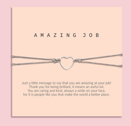 Bracelet with heart charm on a card that says 'Amazing Job' on a pink background. A gift for her to say well done.