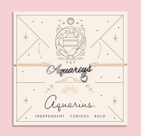 Adjustable peach cord bracelet with a silver 'Aquarius' charm and dangling heart pendant, displayed on a zodiac-themed card with a water bearer illustration and traits reading