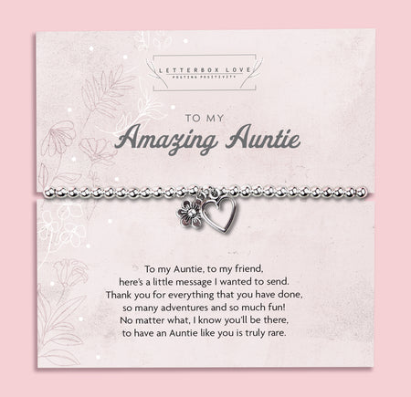 Silver beaded bracelet with heart and flower charms, displayed in a white gift box alongside a card titled