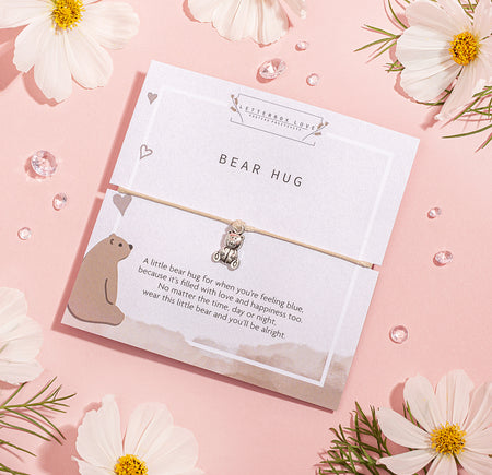 BEAR HUG' bracelet featuring a cute silver bear charm, presented on a white card with a heartwarming message and an illustrated bear.