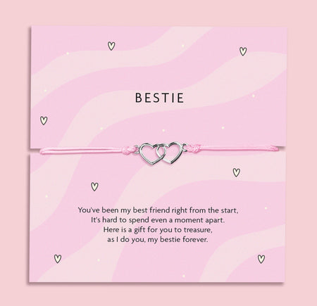 A pink bracelet card with two heart charms, featuring the text