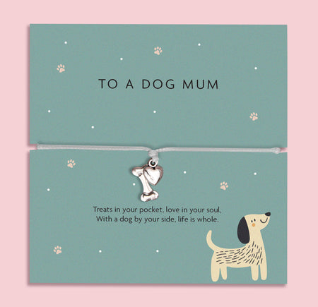 Silver bone and heart charm bracelet for dog mums, featuring a grey cord and a heartfelt sentiment card about the special bond between a dog and its owner.