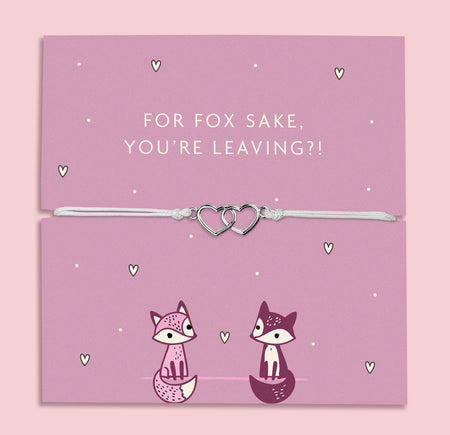 A lilac adjustable bracelet featuring two interlinked heart charms, displayed on a lilac backing card with the playful message