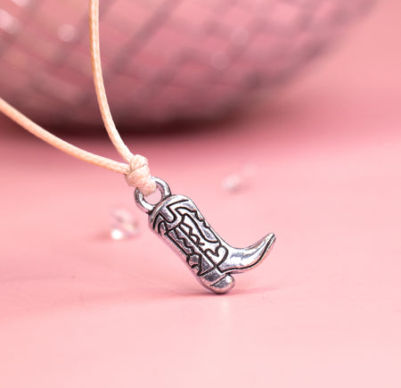 Cute charm cowboy boot with rodeo details on a beige cord. Great gift for hen party favours.