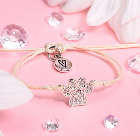 beige friendship bracelet with cute paw charm