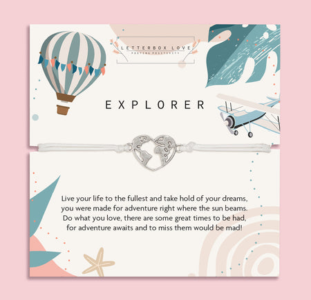 Letterbox Love 'Explorer' travel-themed bracelet – silver heart world map charm on a white cord, displayed on an adventure-inspired card with a hot air balloon, airplane, and uplifting message. Perfect gift for travellers, backpackers, graduates or anyone chasing their dreams. A thoughtful letterbox gift for wanderlust and new journeys.