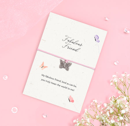 Fabulous Friend bracelet with silver butterfly charm on pink cord, displayed on an A6 plantable seeded card made from recycled cotton, featuring a friendship poem and soft butterfly design.