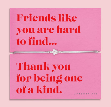 Friendship bracelet for a best friend on a pink and red card. Cute star bracelet on grey string.