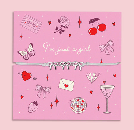 Letterbox Love 'I’m Just a Girl' bracelet – fun and playful bow charm bracelet on a lilac-pink card with 90s-style illustrations including a cassette, cocktail, disco ball, and hearts. Perfect cute gift for teens, Gen Z girls, or best friends, ideal for birthdays, Galentine’s Day, or just because