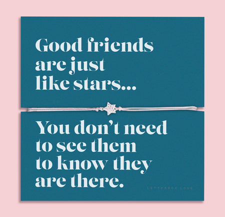 A silver-plated star charm bracelet on an adjustable cord, displayed on a teal backing card with the message: