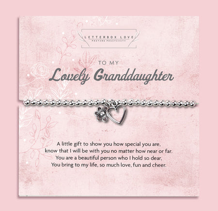 Silver beaded bracelet with heart and flower charms, presented in a white gift box alongside a card titled