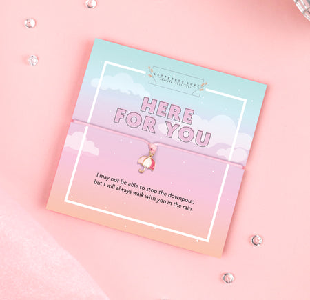 A pastel-colored bracelet card titled