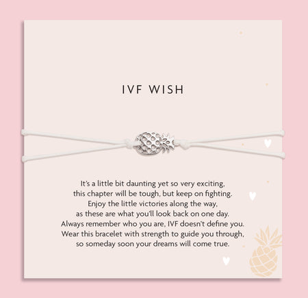 Bracelet with pineapple charm on a card with 'IVF Wish' text against a pink background. A gift for someone beginning IVF.