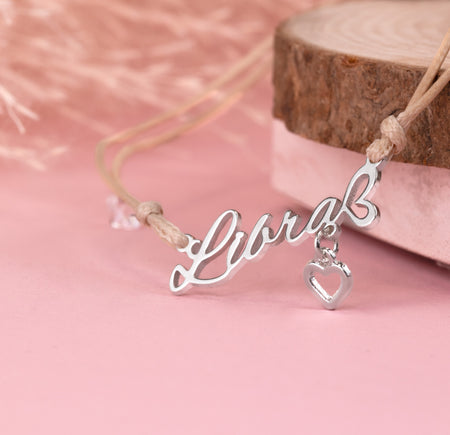 Silver 'Libra' necklace with a heart pendant on a pink background. A meaningful zodiac bracelet gift for her. Star sign jewellery under £20