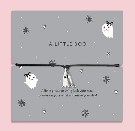 Silver ghost charm bracelet on black cord, displayed on grey Halloween-themed card with spiderweb and heart illustrations.