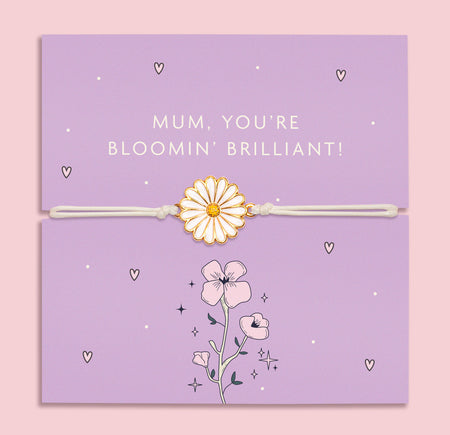A delicate bracelet with an enamel daisy charm on an adjustable white cord, displayed on a lilac backing card with the message