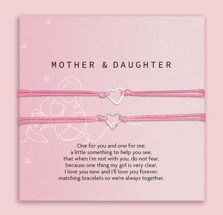 Two pink heart-shaped bracelets on a matching card with text, against a light pink background. A cute gift under £10 for a mother and daughter