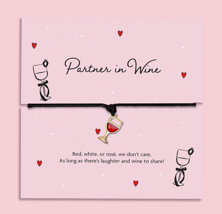 Partner in Wine bracelet featuring a red wine glass charm on a black cord, presented on a fun, illustrated card with a playful sentiment for wine lovers. A fun friendship bracelet for best friends.