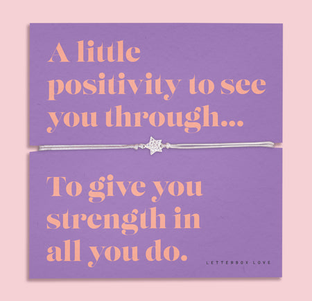 A lavender-colored bracelet card titled