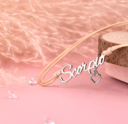 Necklace with 'Scorpio' pendant on a pink background. Zodiac bracelet for women, scorpio birthday gift