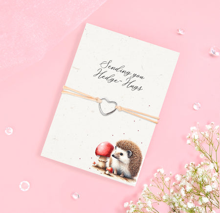 Silver heart charm bracelet with eco-friendly seeded card featuring a hedgehog illustration and the sentiment