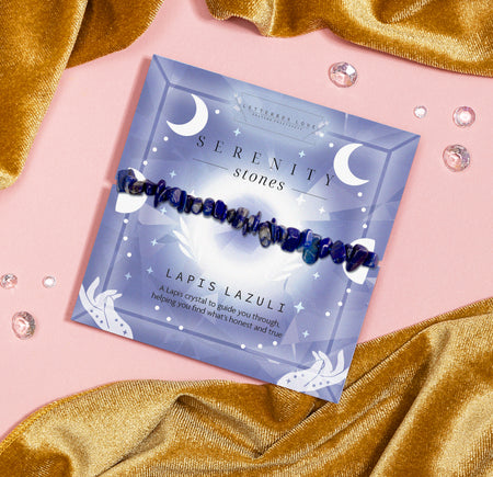 Lapis Lazuli Serenity Stones bracelet featuring blue crystal chips, placed on a celestial-themed card with the words
