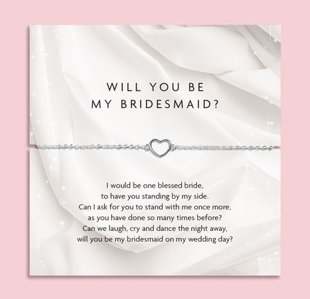 Card with heart-shaped bracelet and 'Will You Be My Bridesmaid?' message on a pink background. A beautiful gift for a bridal party or bridesmaid boxes.
