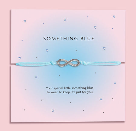 Something Blue wedding bracelet with silver-plated star charm and cubic zirconia on pale blue cord, displayed on a pink poem card.