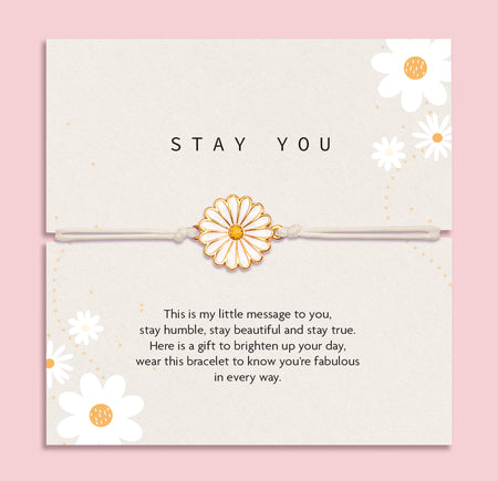 Letterbox Love 'Stay You' daisy bracelet gift – white and gold enamel daisy charm on a neutral cord, presented on a positive message card with floral design. A thoughtful and uplifting jewellery gift for her, perfect for friendship, self-love, encouragement or just because. Ideal letterbox gift to brighten someone’s day.