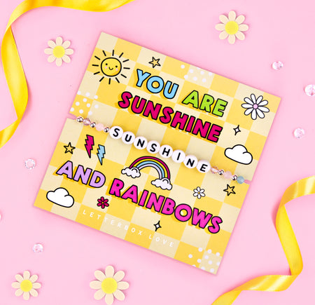 An image of a cheerful motivational card featuring a beaded bracelet with the word