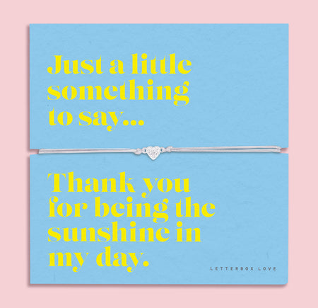 A light blue bracelet card titled