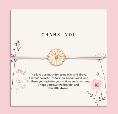 Elegant 'Thank You' card on a blush pink backdrop, adorned with a daisy-inspired bracelet. The card showcases delicate floral illustrations and a heartfelt gratitude message.