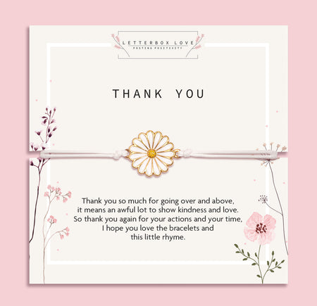 Elegant 'Thank You' card on a blush pink backdrop, adorned with a daisy-inspired bracelet. The card showcases delicate floral illustrations and a heartfelt gratitude message.