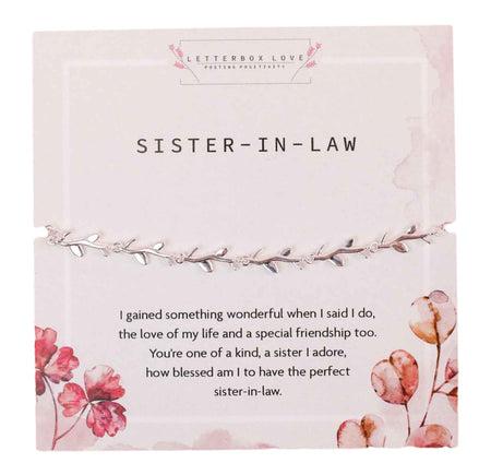A delicate silver bracelet with leaf details, presented on a white card titled 'SISTER-IN-LAW' with pink floral accents. The card includes a heartfelt message expressing gratitude for gaining a sister and friend, celebrating a cherished sister-in-law relationship.