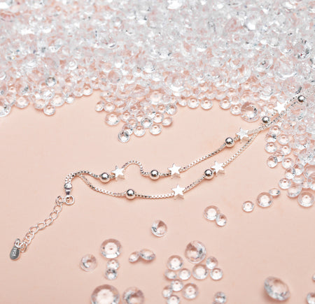Fabulous Friend - Silver Stars Bracelet - letterboxlove. Silver star bracelet on a peach background surrounded by crystals