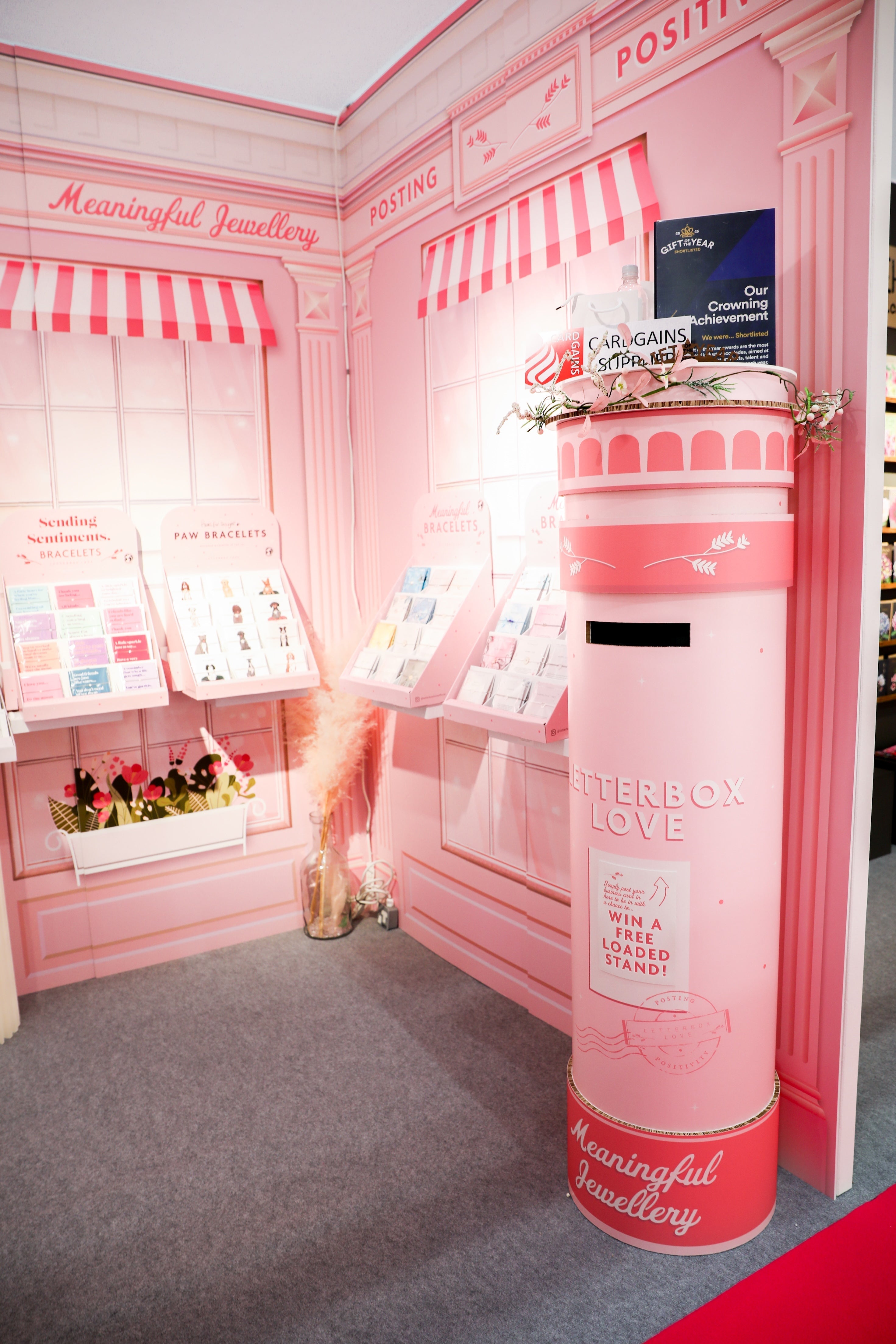 Pink trade show stand for Letterbox Love, with the giant pink postbox