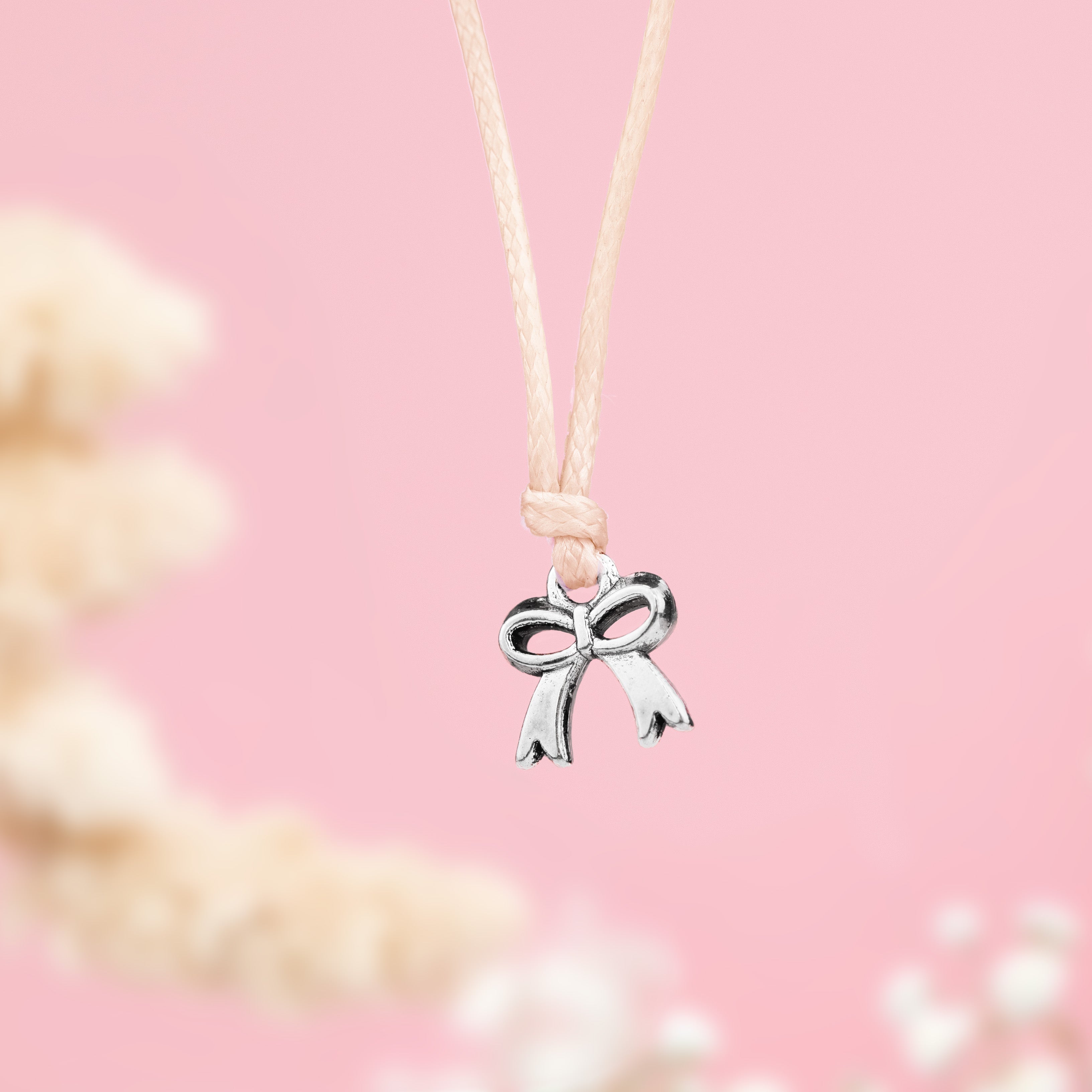 Beige friendship bracelet with a silver-plated bow charm, a cute gift for women