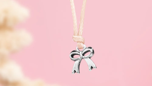 Beige friendship bracelet with a silver-plated bow charm, a cute gift for women