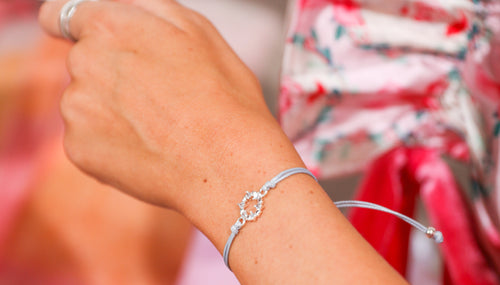 A woman wearing an elegant wreath bracelet. An affordable friendship bracelet, perfect for a Secret Santa Gift.