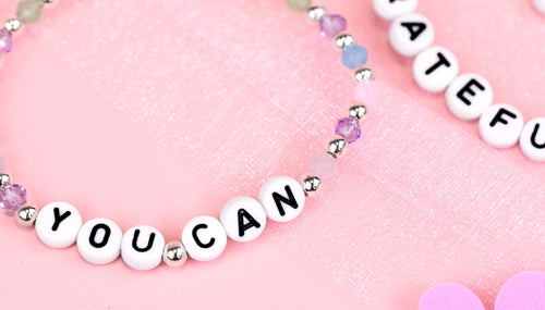 Colourful bead bracelet with "You Can" letters and a pink flower