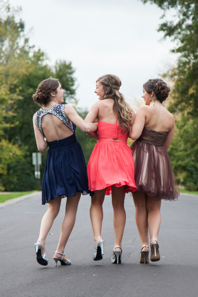 three girls on the way to prom in colourful dresses