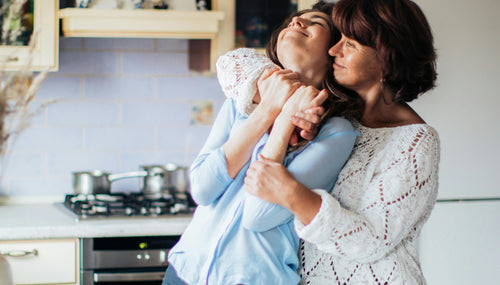 A mother and daughter embracing in a kitchen for mothers day 2026