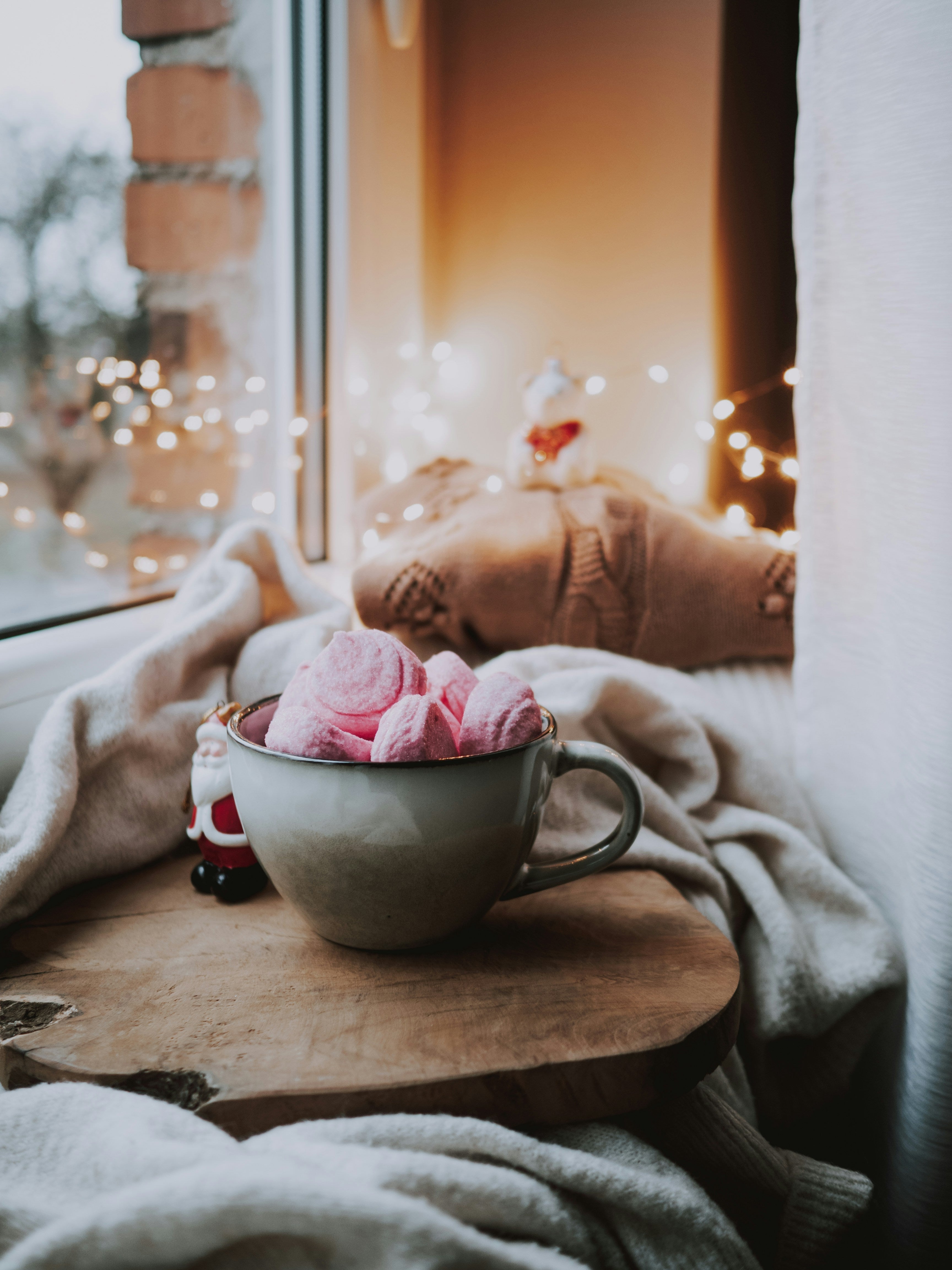 a winter window ledge with hot drink and mug