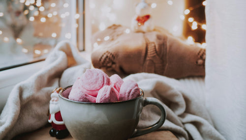 a winter window ledge with hot drink and mug