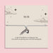 White adjustable 11:11 angel number bracelet with silver-tone feather and heart charms, displayed on a celestial sentiment card with a manifestation and abundance message.