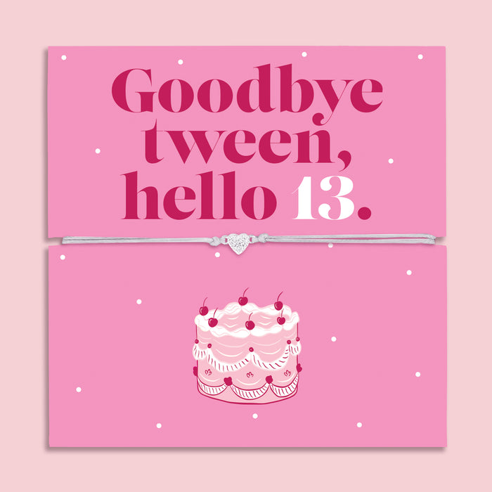 13th birthday bracelet with sparkling zircon heart charm on an adjustable cord, displayed on a pink “Goodbye Tween, Hello 13” message card with birthday cake illustration.