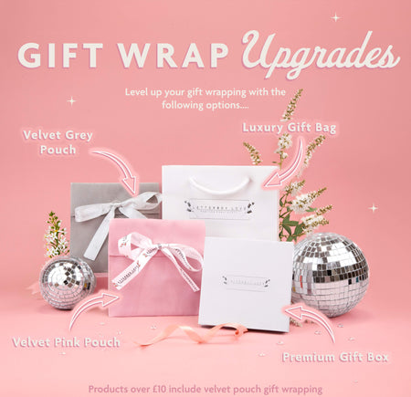 a pink background with a silver gift bag and two silver disco balls