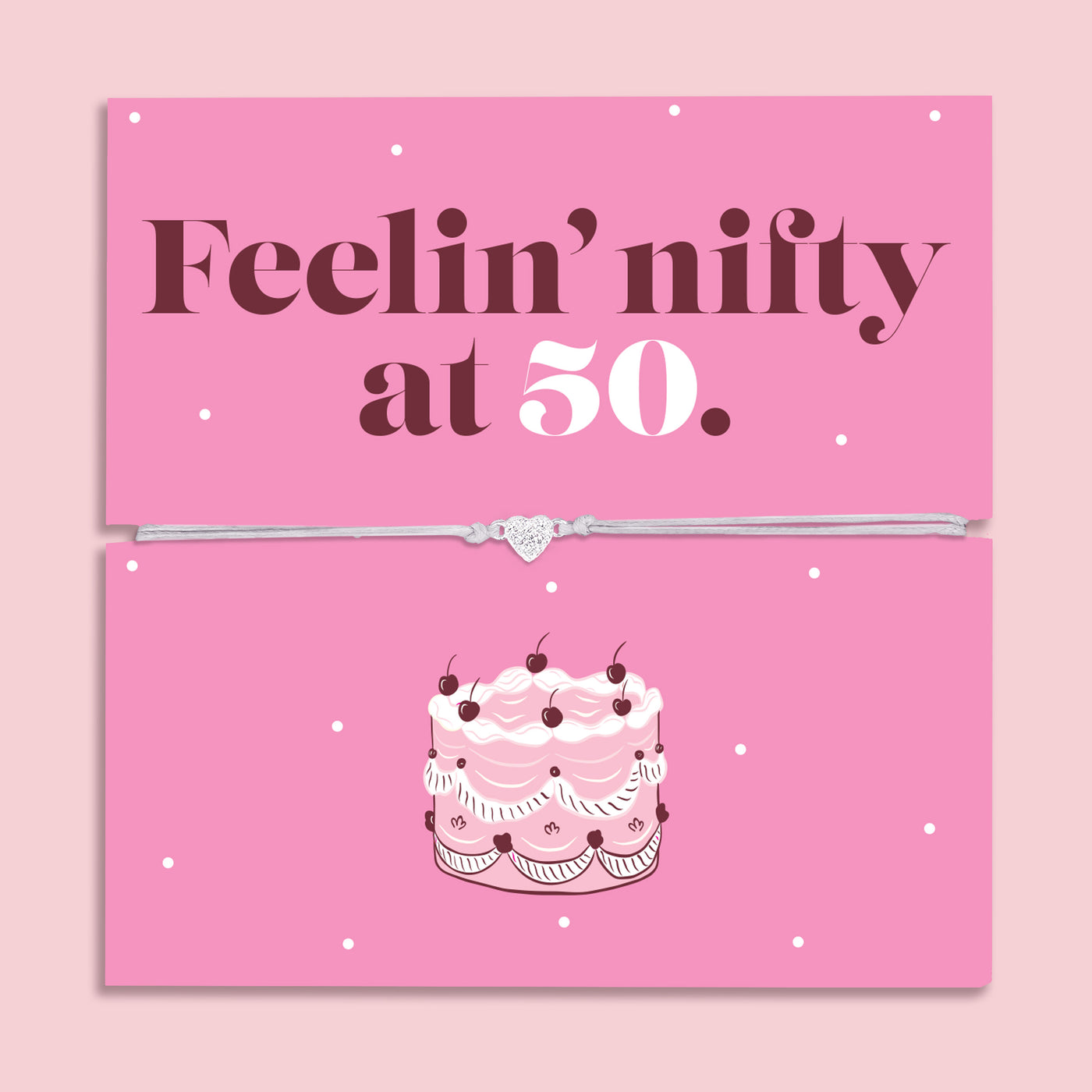 Pink 50th birthday gift card with the text “Feelin’ nifty at 50” in bold brown and white lettering, featuring a silver and grey adjustable heart charm bracelet across the centre and an illustrated birthday cake below.
