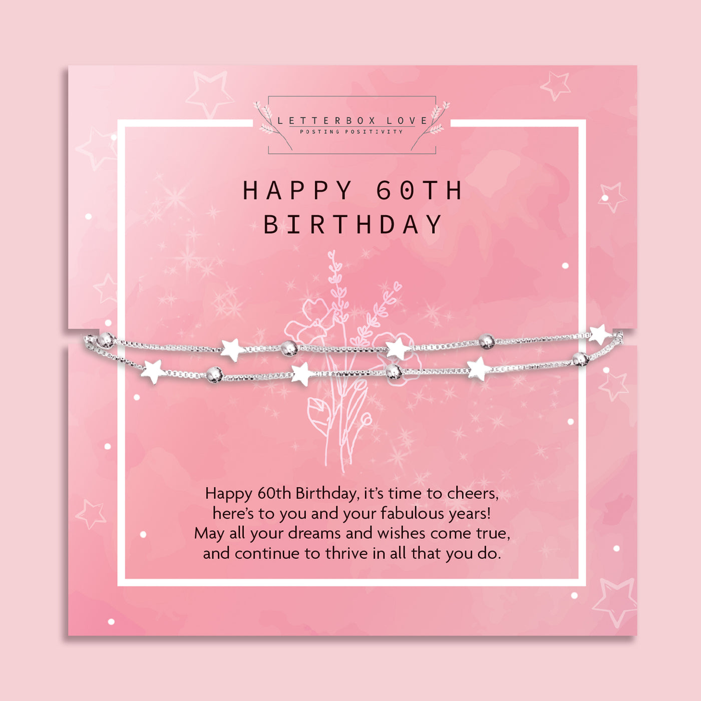 A celebratory 60th birthday bracelet by Letterbox Love, displayed on a soft pink background with glistening white flowers. The bracelet features a silver chain interspersed with shimmering stars and beads, conveying elegance and joy. It lies atop a matching pink birthday card that reads 