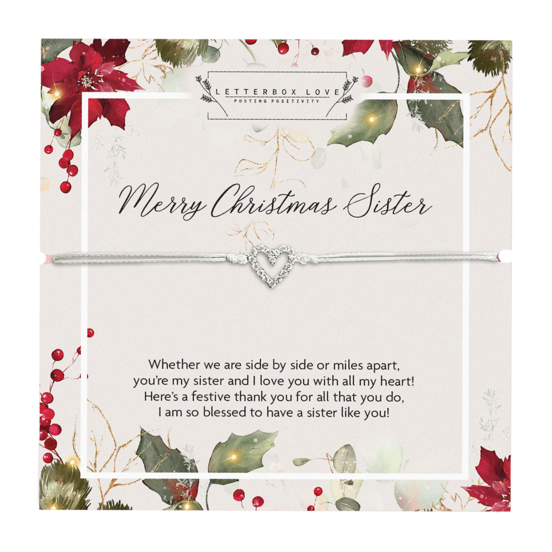 A delicate bracelet with a silver heart charm displayed on a festive card titled 